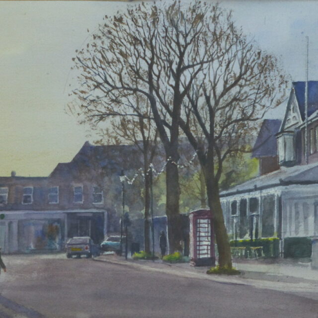 A watercolour painting of Birkdale Village, Southport in the early morning with people crossing the road in front of the old phone box which glows in the light.