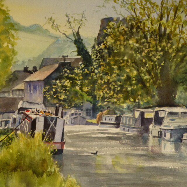 A watercolour painting of the canal and narrowboats at Parbold with buildings behind and behind them a glimpse of the hill.