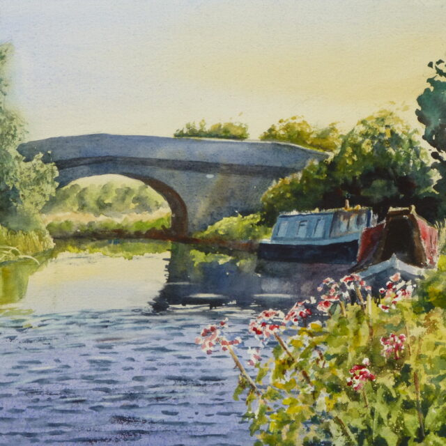 A watercolour painting of the Rufford Branch canal with moored narrowboats nestling up against the old arched stone bridge. Lush vegetation surround the banks and a breeze ripples the water.