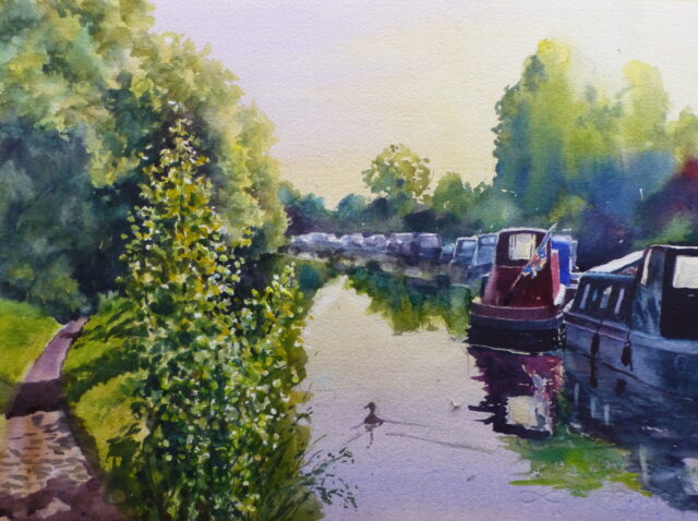 A watercolour painting of the Leed/Liverpool canal at Scarisbrick with moored narrowboats and the view of the path as it disappears under the canal-side trees.