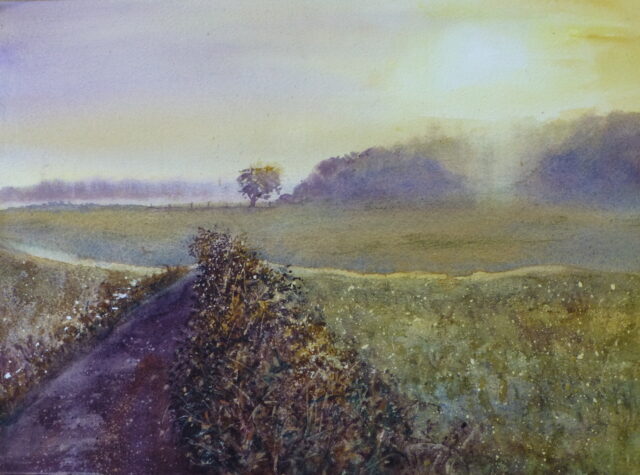 A watercolour painting of the sunrise as it comes over a copse on Clieves' Hills, outside Ormskirk. Mist hangs about distant trees and a lone tree stands by a fence in a field.