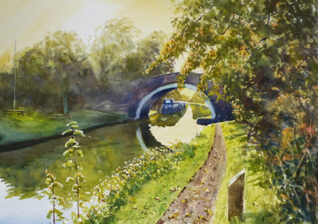A watercolour painting of a canal scene at Lydiate with bridge and distant moored narrowboats with sunshine on the surrounding autumnal trees.