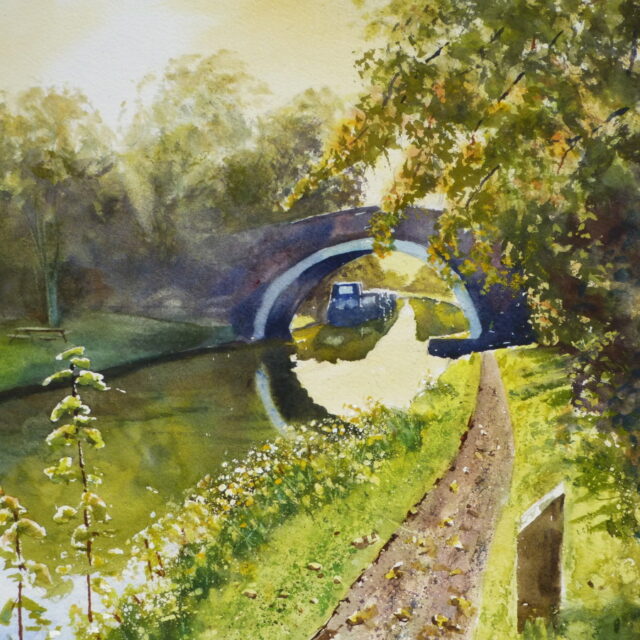 A watercolour painting of a canal scene at Lydiate with bridge and distant moored narrowboats with sunshine on the surrounding autumnal trees.
