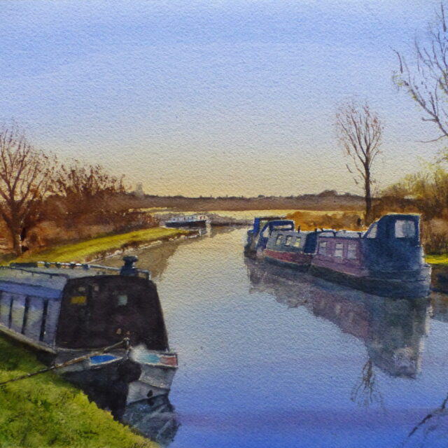 A watercolour painting of narrowboats moored on the Leeds/Liverpool canal at Burscough on a bright winter's day with reflections in the water.