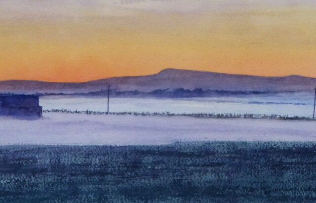 A watercolour painting of Rivington Pike seen across a misty Southport moss on a still morning with a glowing sunrise behind the hill.