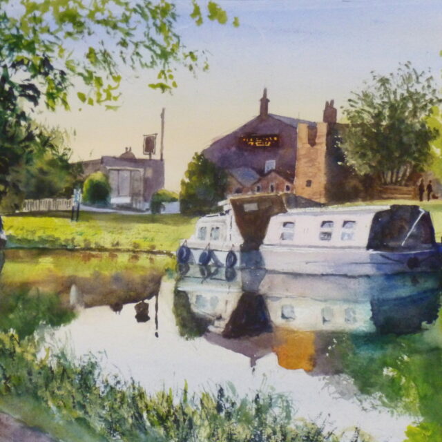 A view of the Leeds to Liverpool Canal and moored narrowboats at the Heatons Bridge Inn